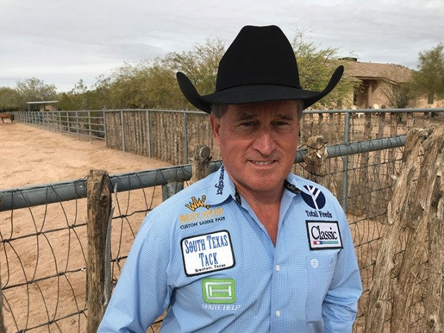 Bret Beach wearing black felt cowboy hat and logoed long sleeve shirt