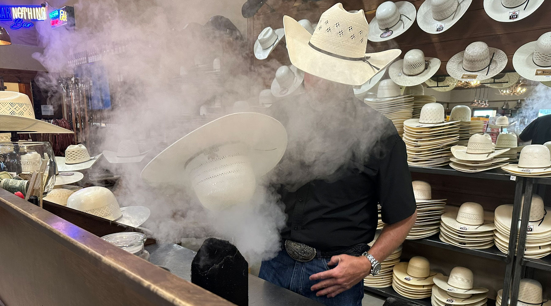 Olin shaping a cowboy hat with steam