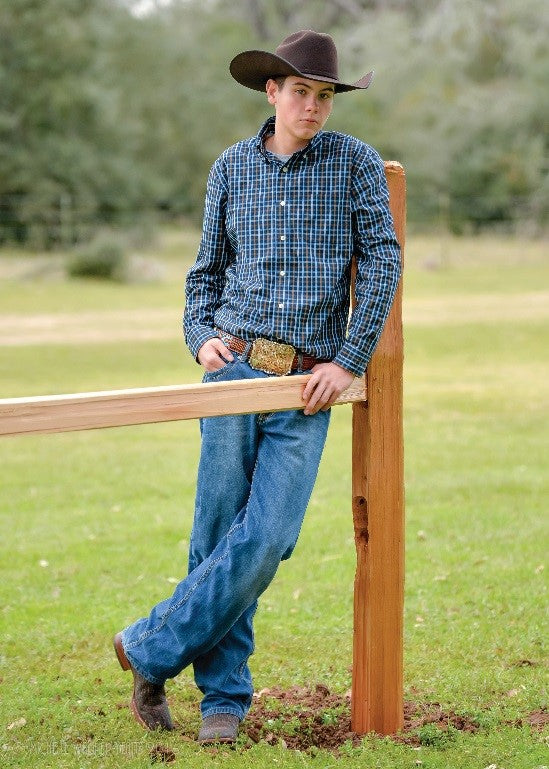 Cody leaning on fence at Miracle Farms